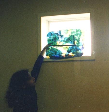 Worton Road Community Centre, Environmental Theme Mural project, Isleworth, 1997.. Another co-production for and by the community, via Making Murals. Isabella's daughter, Francesca Demetriou, holds her work up to the light!